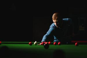 Playing billiard - Close-up shot of a man playing billiard photo