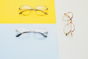 Poster of glasses on pastel background. Optics. Vision. photo