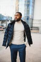 African American man in stylish new clothes on the street photo