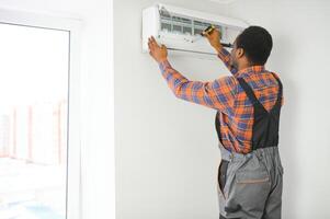 AC Electrician Technician Repairing Air Conditioner Appliance photo