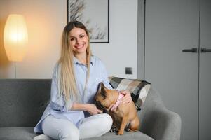 Young woman with her cute dog at home. Lovely pet photo