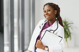 beautiful african american nurse with arms folded. photo