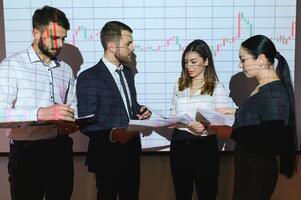 Analyzing data, graphs and reports for investment purposes. Creative teamwork traders. photo