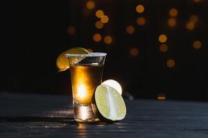 Mexican tequila with lime and salt on rustic wood background. space for text. concept luxury drink. Alcoholic drink concept. photo