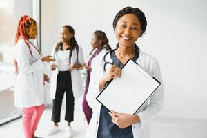 group of young african medical workers on white background. photo