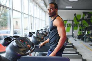Black African American young man doing cardio workout at the gym photo