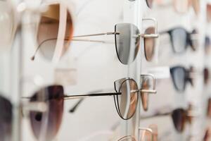 rack with glasses and sunglasses close up. photo