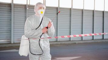 a person in a white suit with water spraying tools video