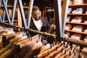 African American man, clothing store, chooses clothes photo