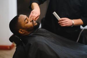 Young African-american man visiting barbershop photo