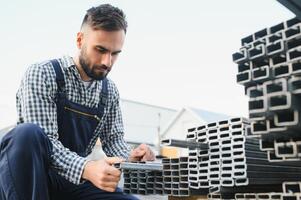 Man chooses metal profile for construction photo