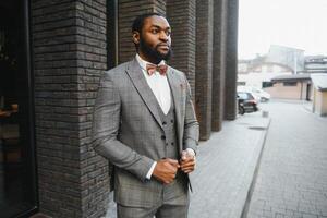 Portrait of an African American businessman wearing a suit standing in an outdoor business environment photo