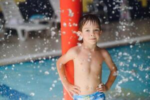 Boy having fun in aqua park photo