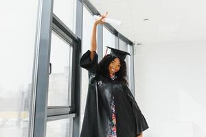 Excited African American woman at her graduation. photo