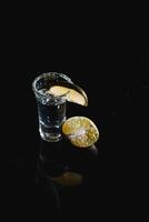 tequila with lime on a dark background photo