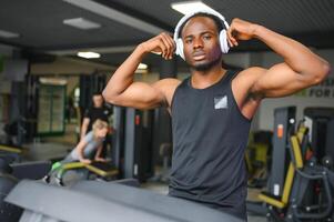 Man running on treadmill in gym photo