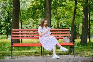 Pregnant woman resting in the park photo