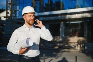 portrait of a young architect or engineer on a construction site photo