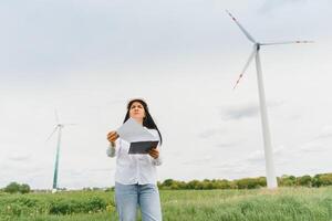 Female Engineer in a Wind Turbines Farm photo