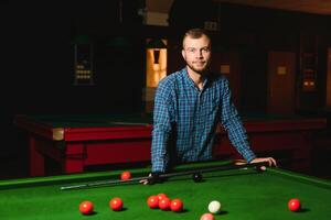 Man playing billiards in a club photo