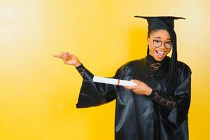 cheerful african american graduate student with diploma in her hand photo