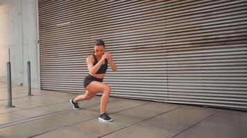 a woman in black shorts and a black top is doing stretching exercise outdoor video