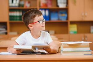 Little child writing with colorful pencils, indoors. Elementary school and education. Kid learning writing letters and numbers. photo