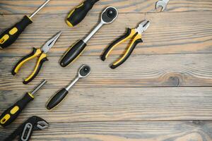 Various tools on wooden background photo