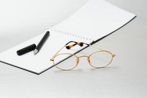 notebook, glasses, pen on a white background top view, school, education, knowledge photo