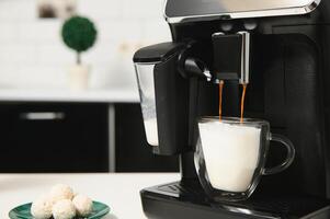 Home professional coffee machine with cappuccino cup. coffee machine latte macchiato cappuccino milk foam prepare concept photo