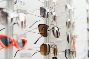 rack with glasses and sunglasses close up. photo