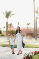 Happy family, mom and baby walking, summer vacation photo