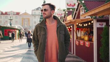 a man in a green jacket walking down a street video