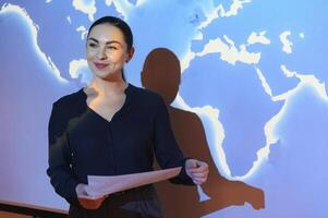 Globe business concept - happy business woman with world map background. photo