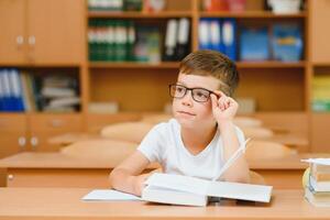 School boy in classroom at lesson photo