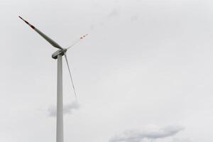 Windmill against cloudy sky with copyspace photo