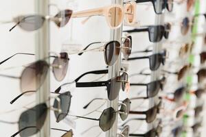 rack with glasses and sunglasses close up. photo