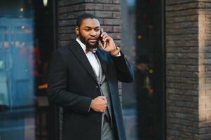 Portrait of an African American businessman wearing a suit standing in an outdoor business environment photo