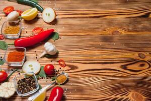 Cooking table. Background with spices and vegetables. Top view. Free space for your text. photo