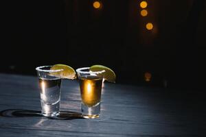 Mexican tequila with lime and salt on rustic wood background. space for text. concept luxury drink. Alcoholic drink concept. photo