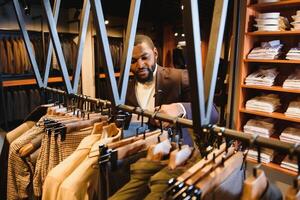 A stylish elegantly dressed African-American man working at classic menswear store. photo