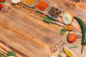 Cooking table. Background with spices and vegetables. Top view. Free space for your text. photo