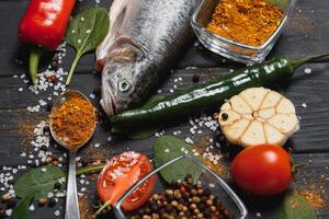 fresh trout with spices and seasonings top view, flat lay photo