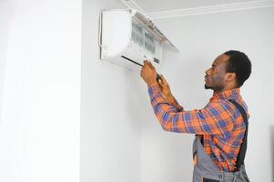 AC Electrician Technician Repairing Air Conditioner Appliance photo