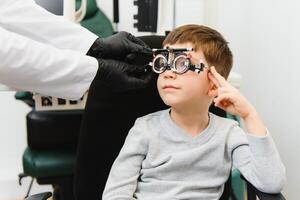 Trial frame. Glasses for a little boy. Hypermetropia. Ametropia correction with glasses photo