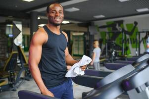 Man running on treadmill in gym photo