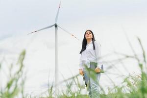 Female Engineer in a Wind Turbines Farm photo