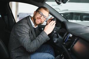 His true love. Portrait of a mature man smiling happily sitting in a brand new car photo