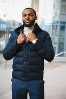 African American man in stylish new clothes on the street photo