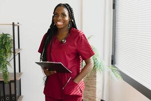 Portrait Of Smiling Female Doctor Wearing White Coat With Stethoscope In Hospital Office. photo